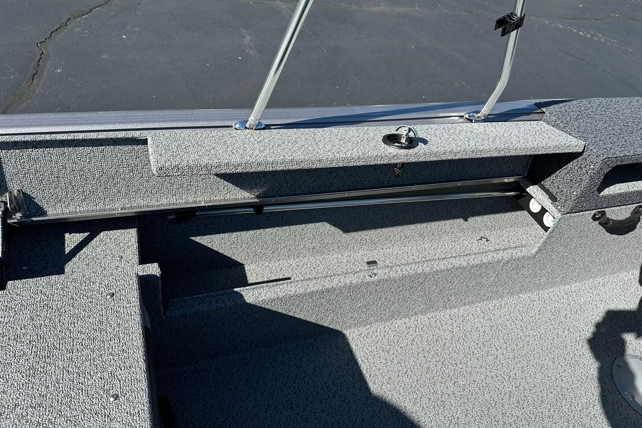 2026 Lund 1875 Impact XS Sport boat interior with gray textured flooring.