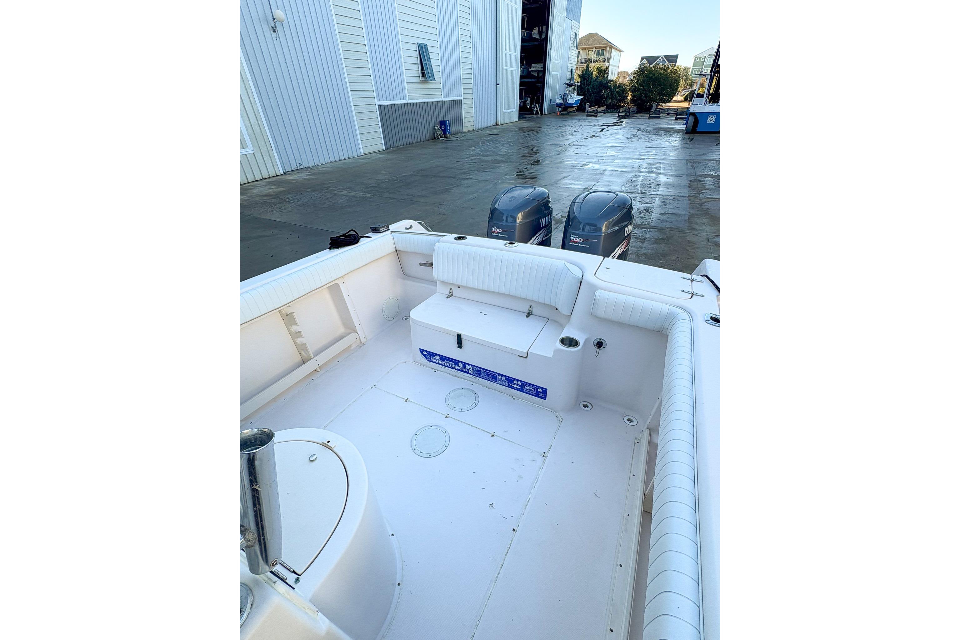 2001 Grady-White Chase 263 boat interior with twin Yamaha engines in a marina setting.