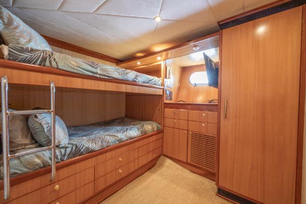2001 Grand Harbour 76 yacht cabin with bunk beds, wooden cabinetry, and a small window.