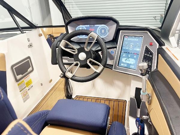 2022 MasterCraft NXT24 boat cockpit with modern steering wheel and digital display.