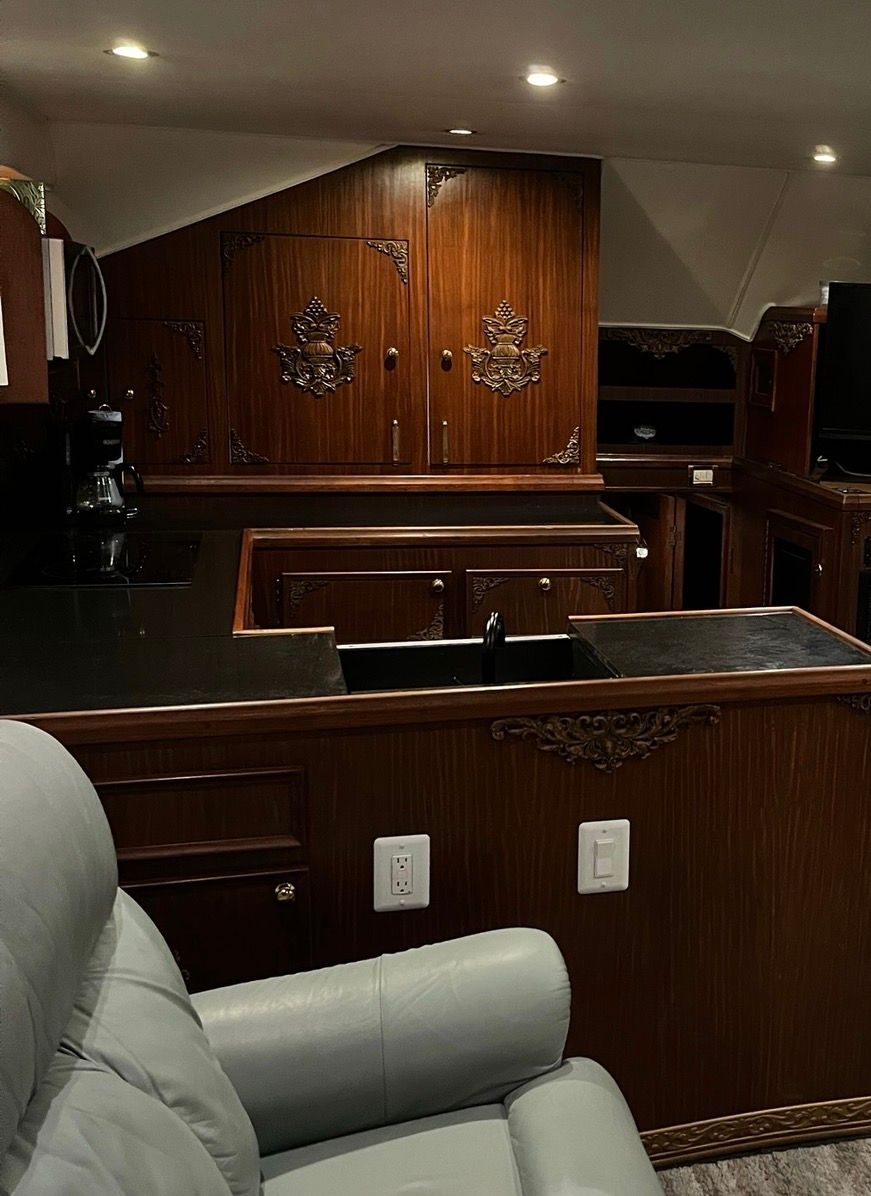 Interior of a 1979 Hatteras sport fishing yacht with elegant wood paneling and comfortable seating.