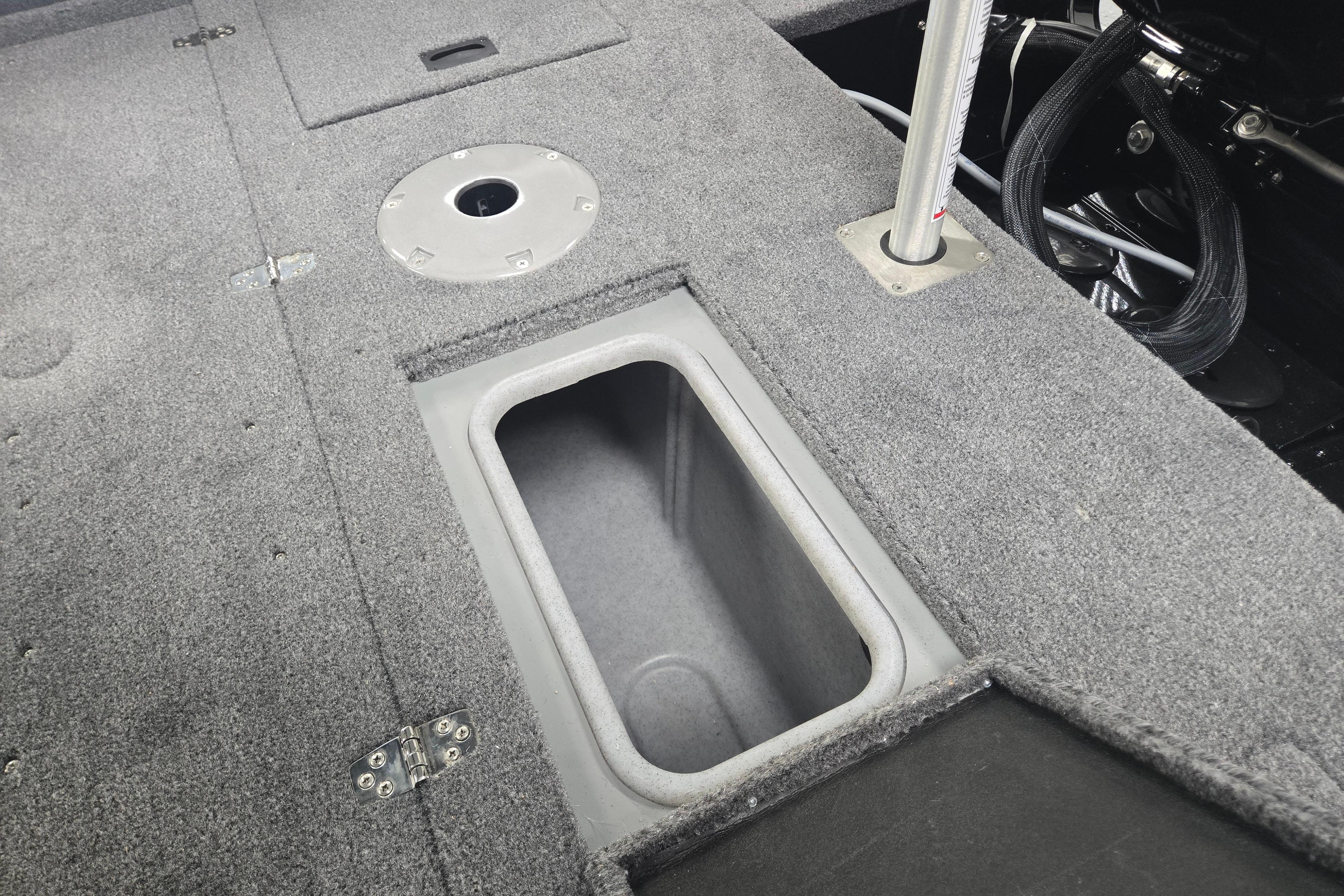 2026 Princecraft Sport 175 MAX boat interior with storage compartment and carpeted flooring.