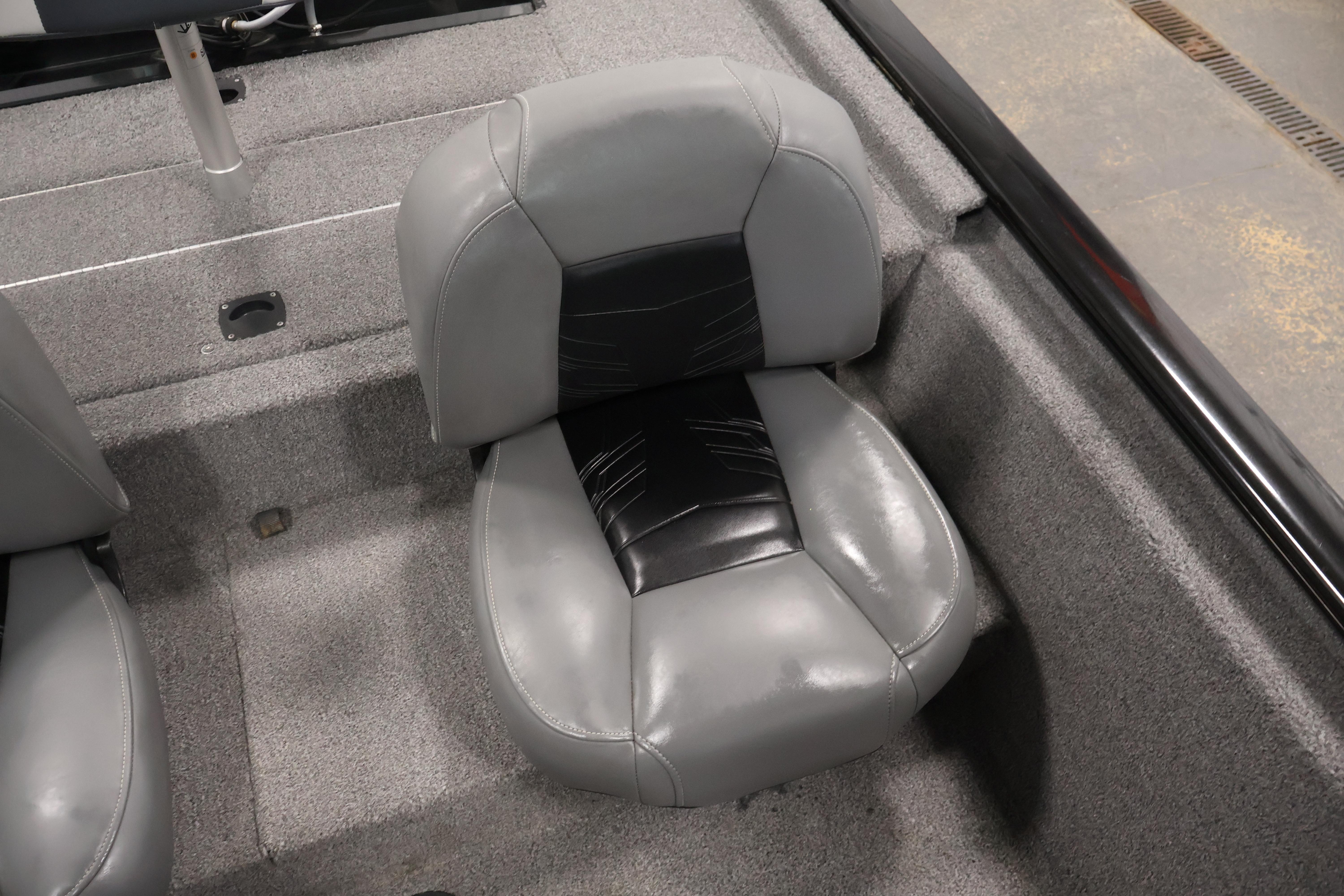 2024 Tracker Pro 170 boat seat, featuring gray and black upholstery, on a carpeted deck.