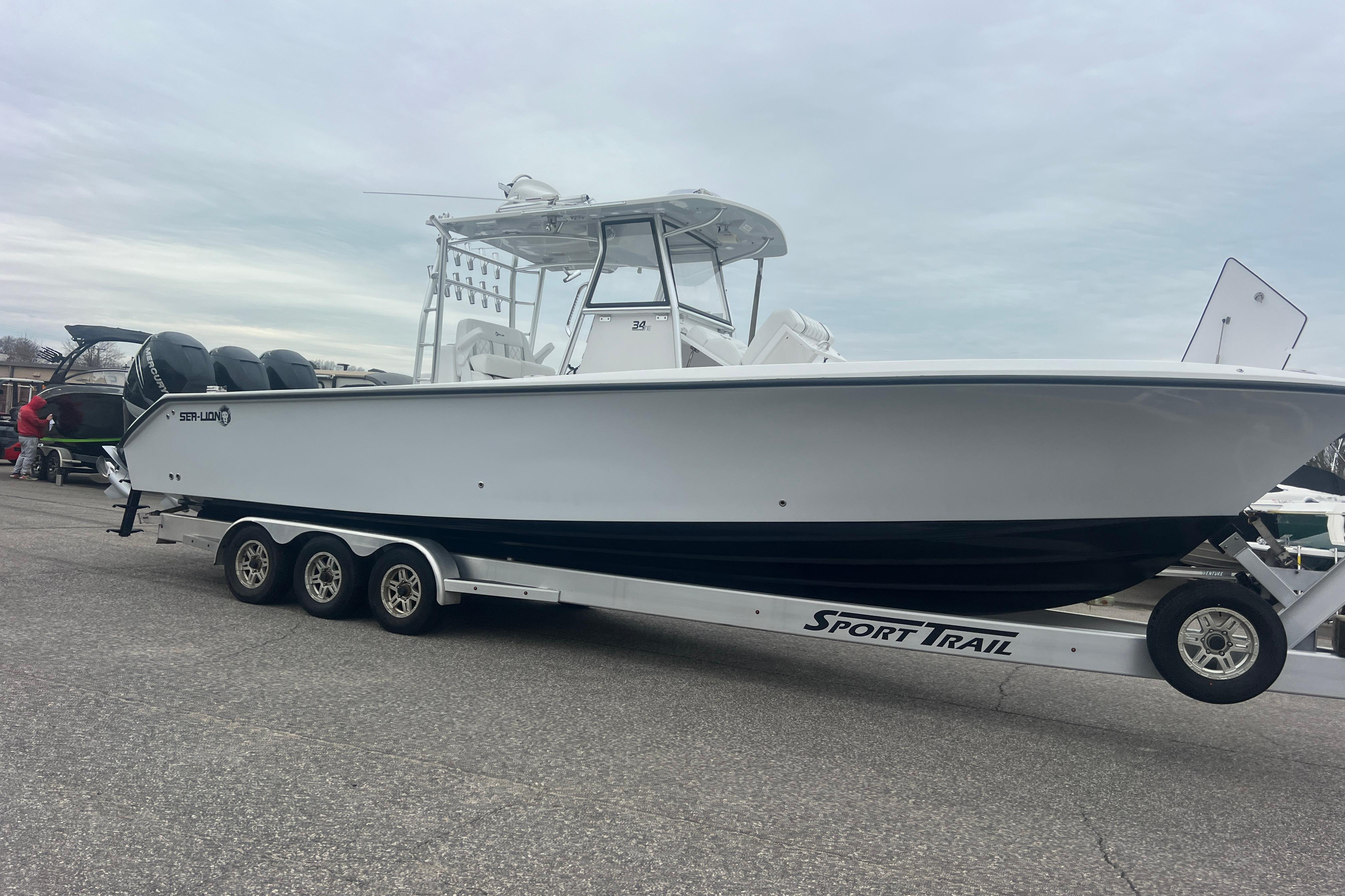 2022 Sea-Lion 34 TE boat on Sport Trail trailer, parked outdoors.