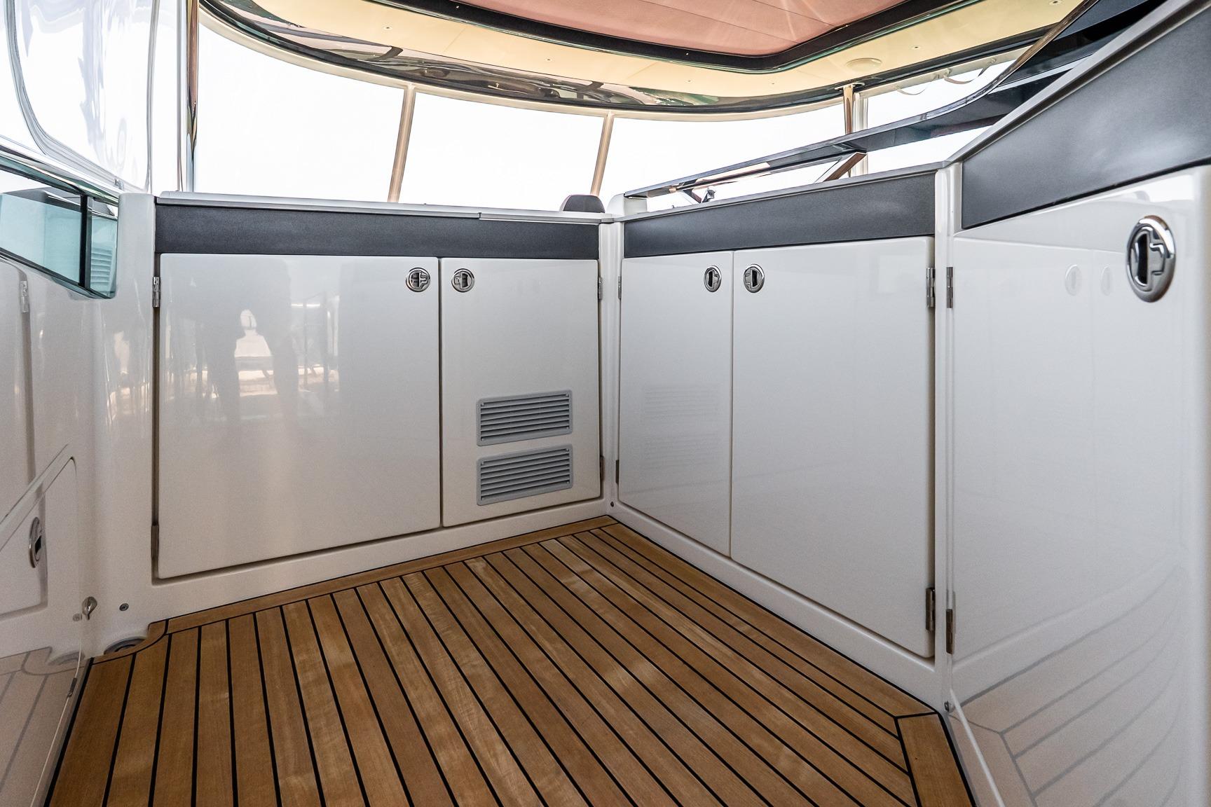 Interior view of 2022 Absolute 64 Navetta yacht with sleek cabinetry and wooden flooring.