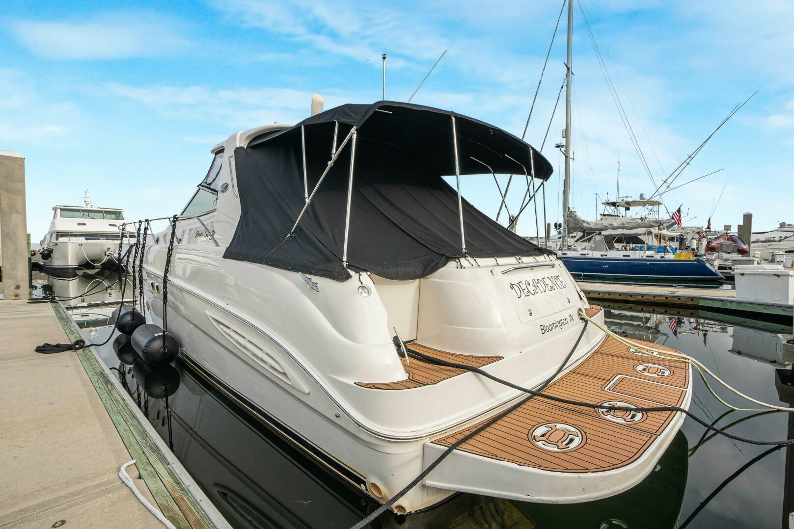 2003 Sea Ray Sundancer 460 yacht docked at marina with covered deck.