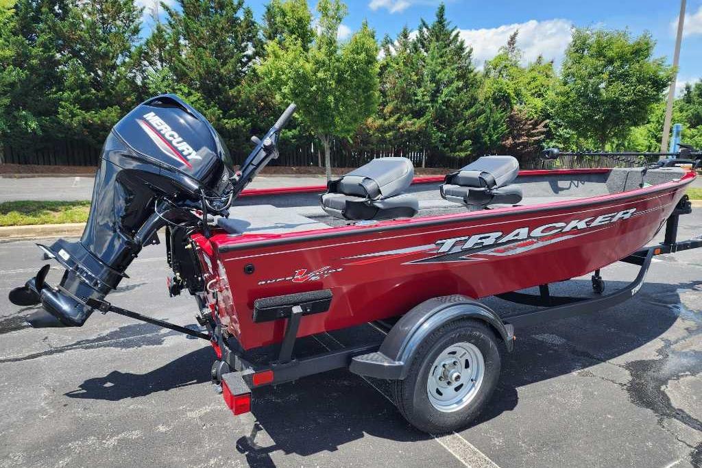 2025 Tracker Super Guide V-16 T boat with Mercury outboard motor, parked outdoors.