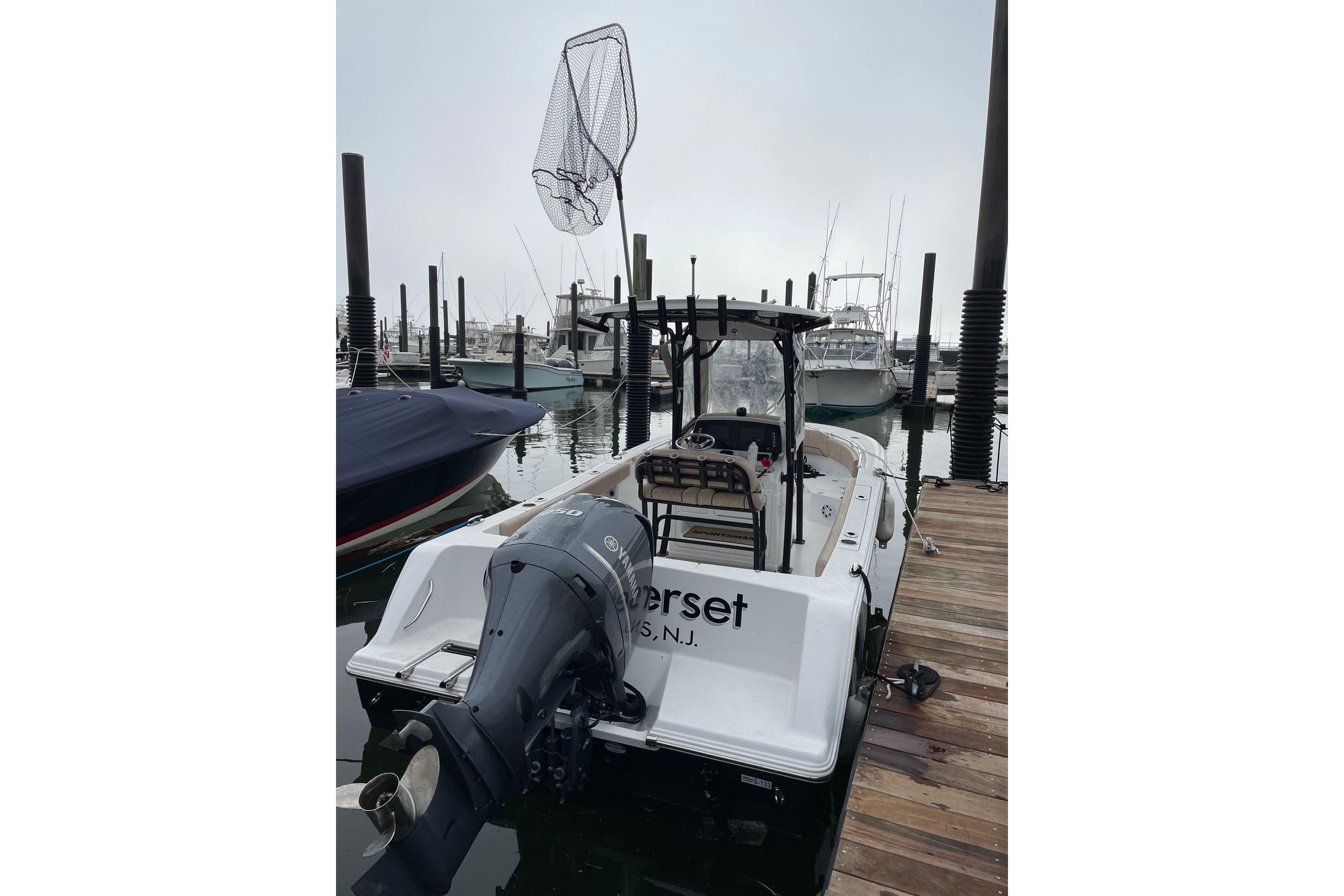 2019 Sportsman Heritage 231 Center Console boat docked at marina.