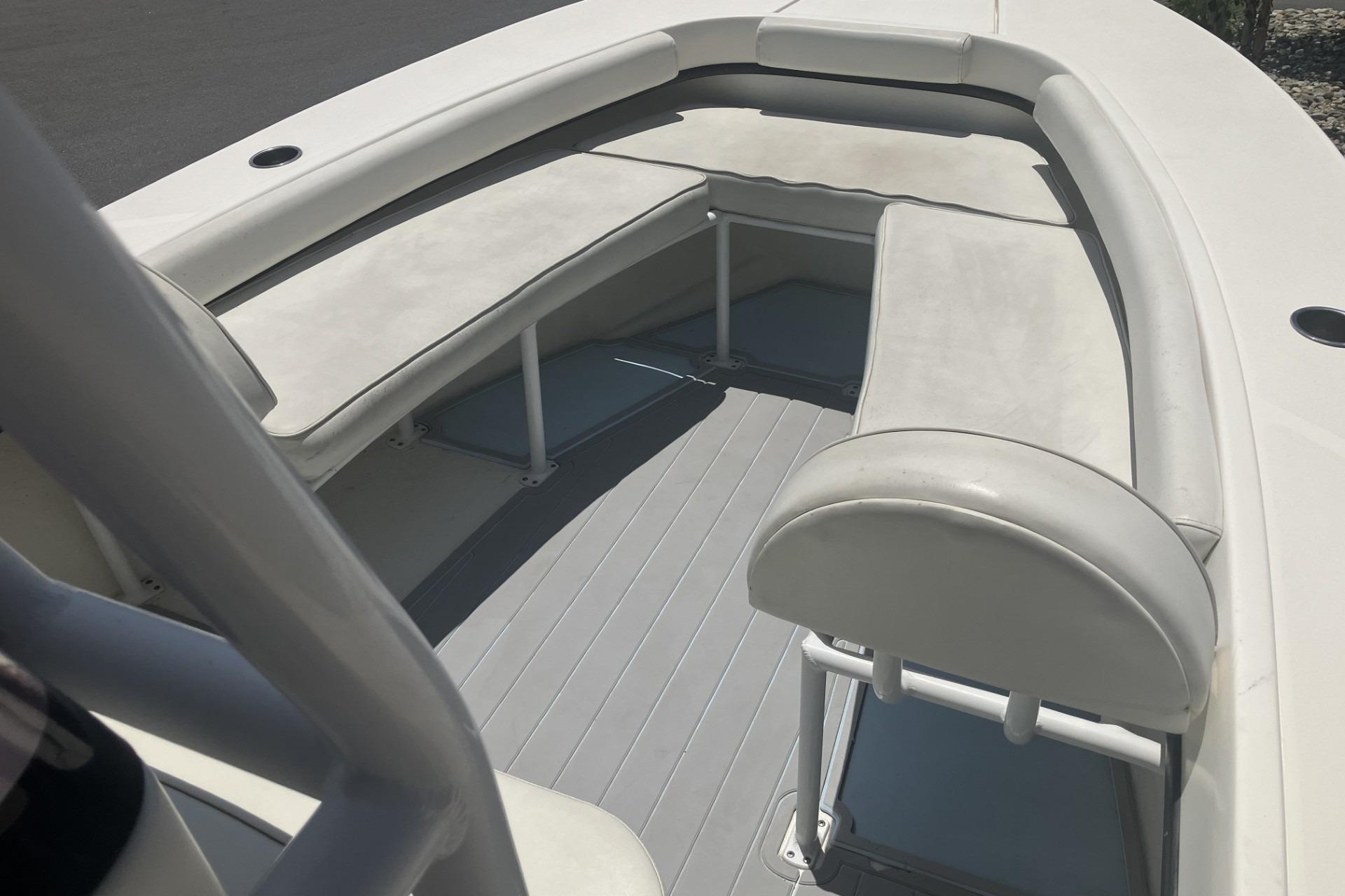 2022 May-Craft 2300 CCX boat interior with cushioned seating and sleek design.