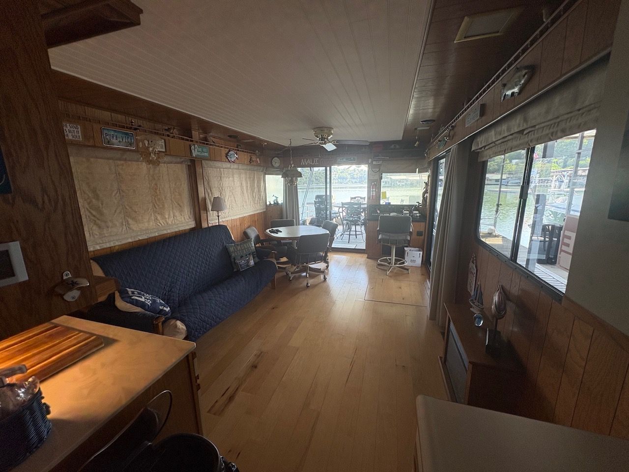 Interior of a 1989 Sumerset houseboat with wooden walls and large windows.