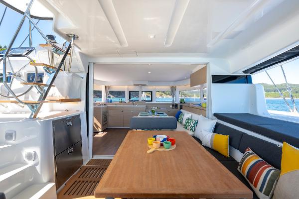 Luxurious interior of 2025 Lagoon 43 yacht with modern kitchen and seating area.