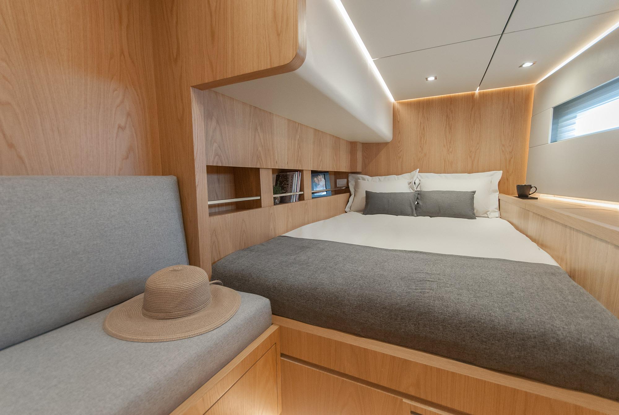 Luxurious cabin interior of 2027 MCP Global Exp 68 yacht with modern wood finish.