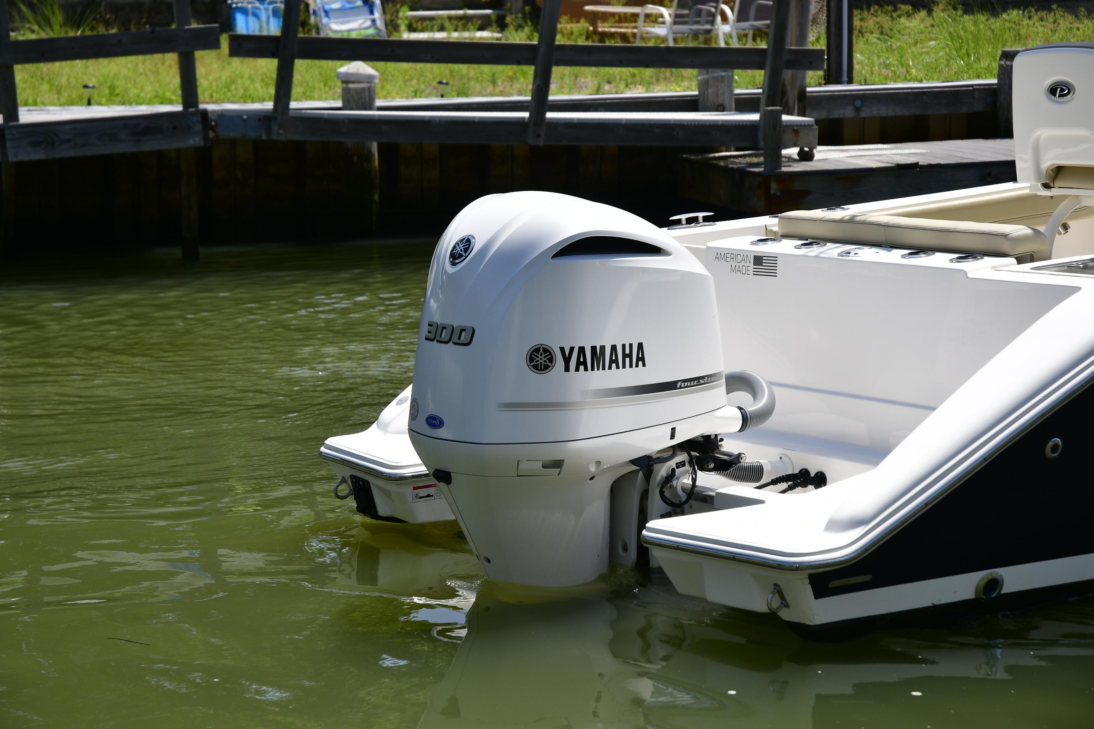 2020 Pursuit C 238 Center Console with Yamaha outboard motor in water.