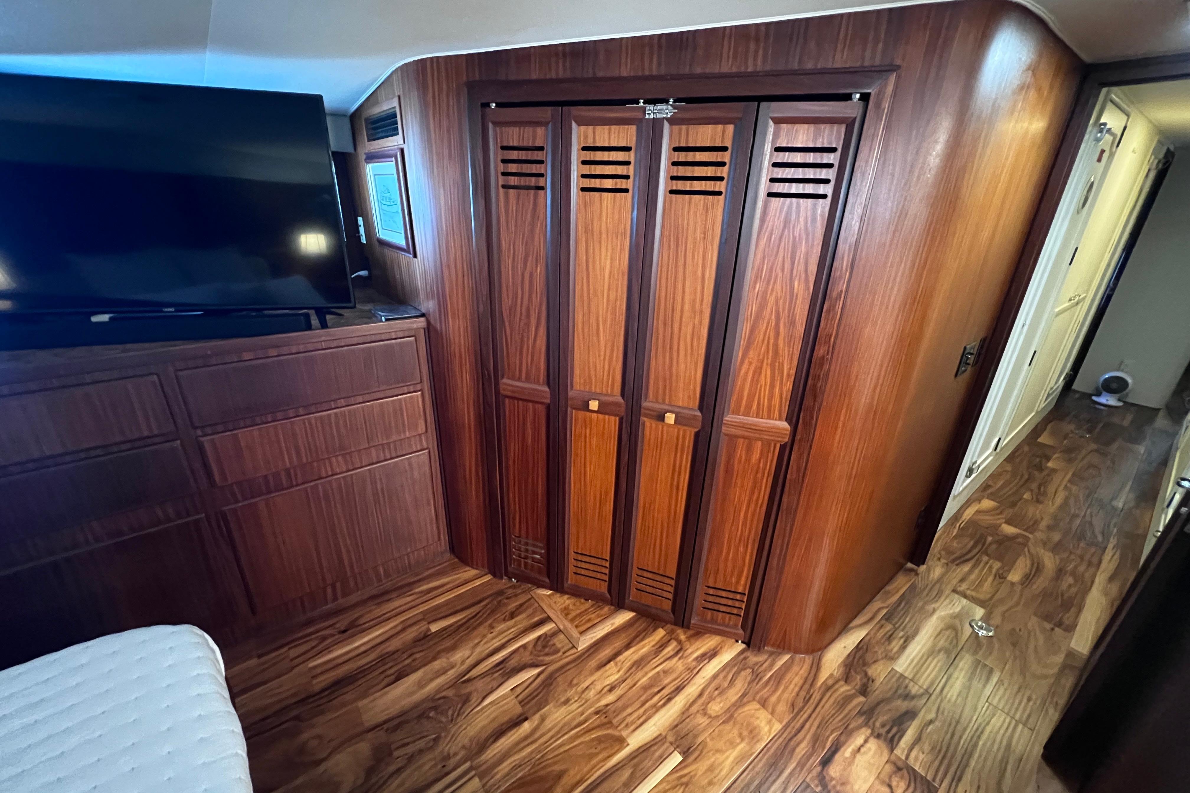 Interior of 1987 Hatteras 70 Cockpit Motor Yacht with wood paneling and TV.