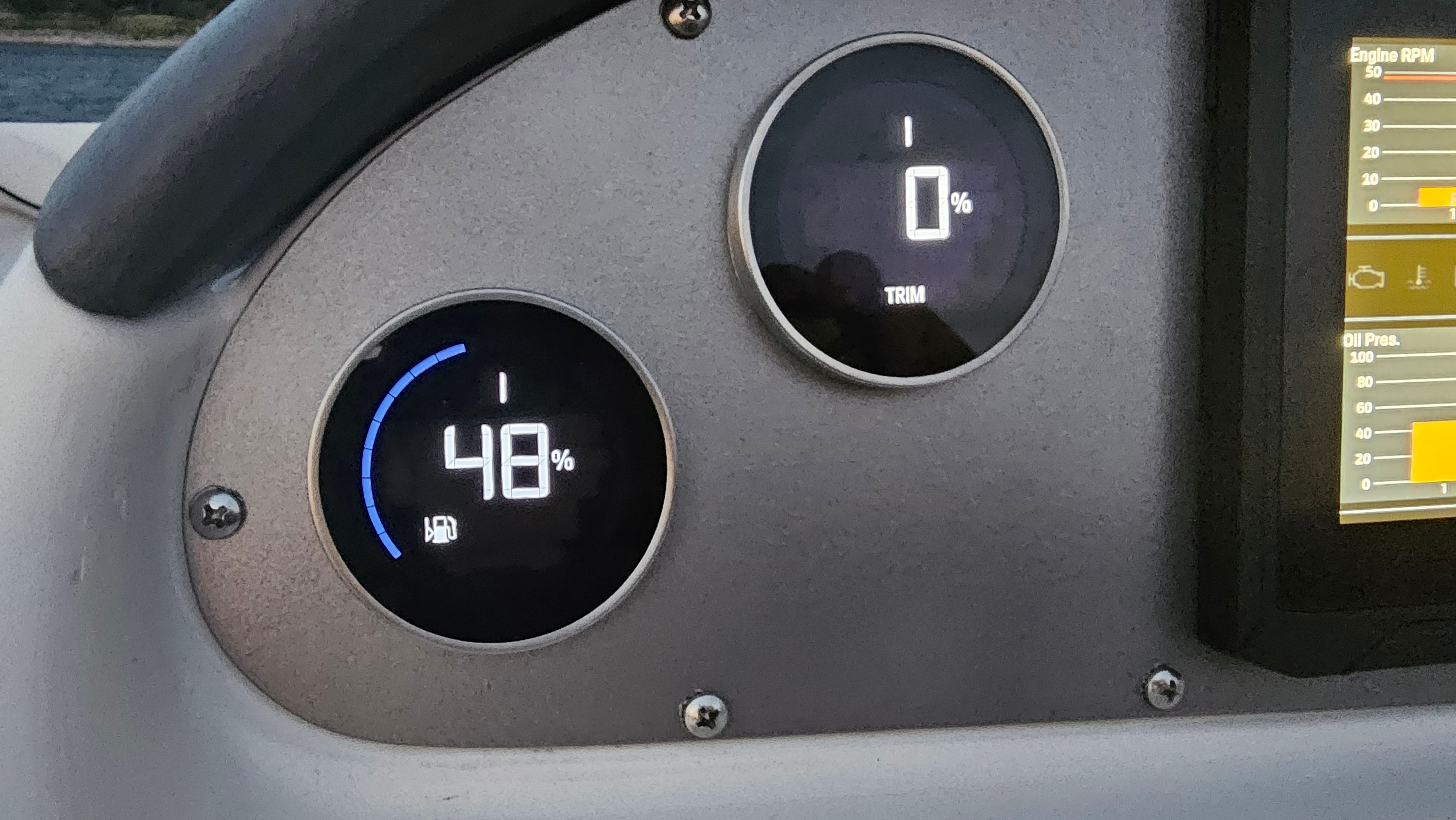 Two round gauges on a boat panel display 48% and 0%.