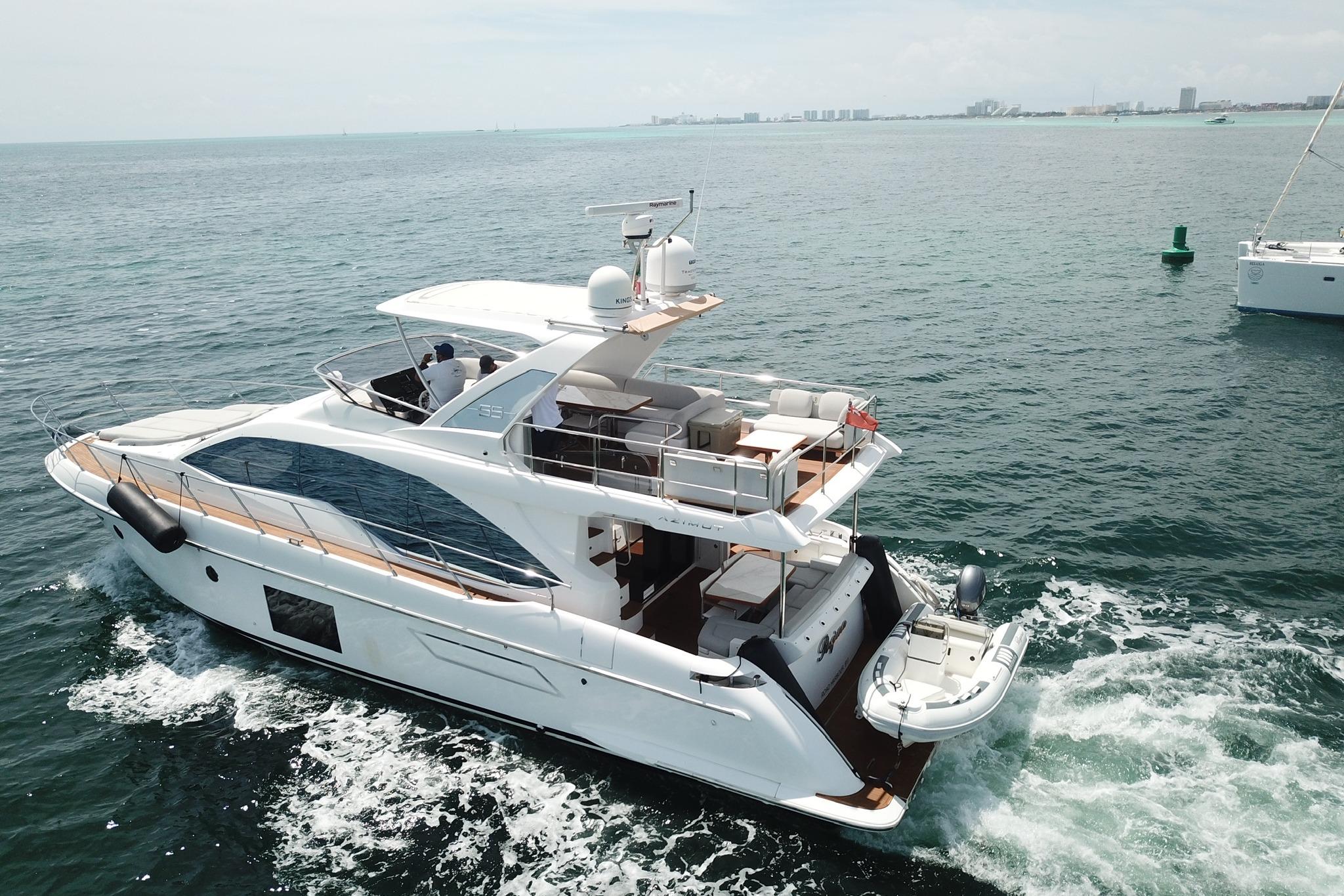 Luxurious 2021 Azimut 55 yacht cruising on open water, showcasing sleek design and spacious deck.