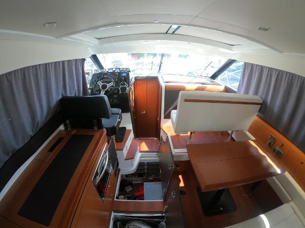 Interior of 2017 Jeanneau NC 11 boat with modern wood finish and seating.