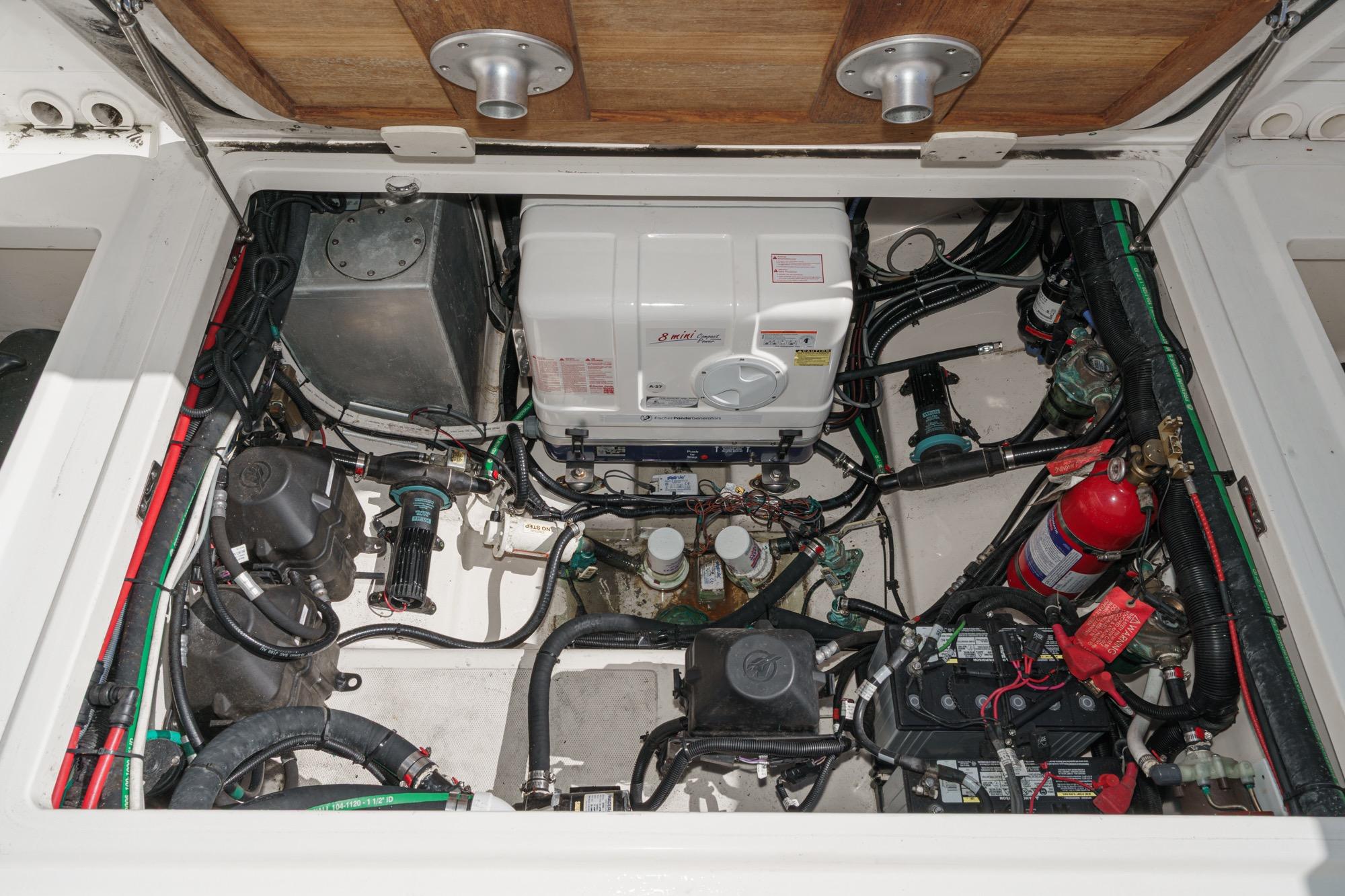 Engine compartment of a 2015 Boston Whaler 370 Outrage, showcasing mechanical components and wiring.