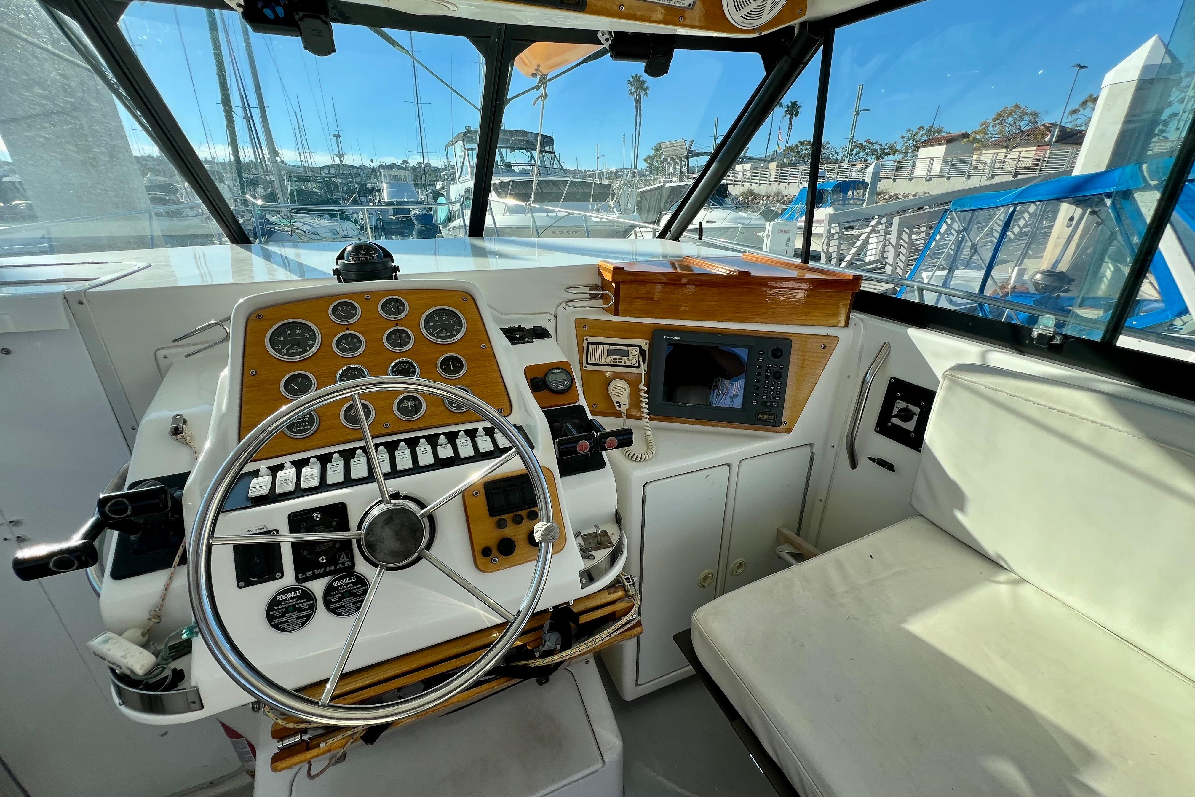 Cockpit of 1998 Baha Cruisers 340 CAT with steering wheel and navigation instruments.