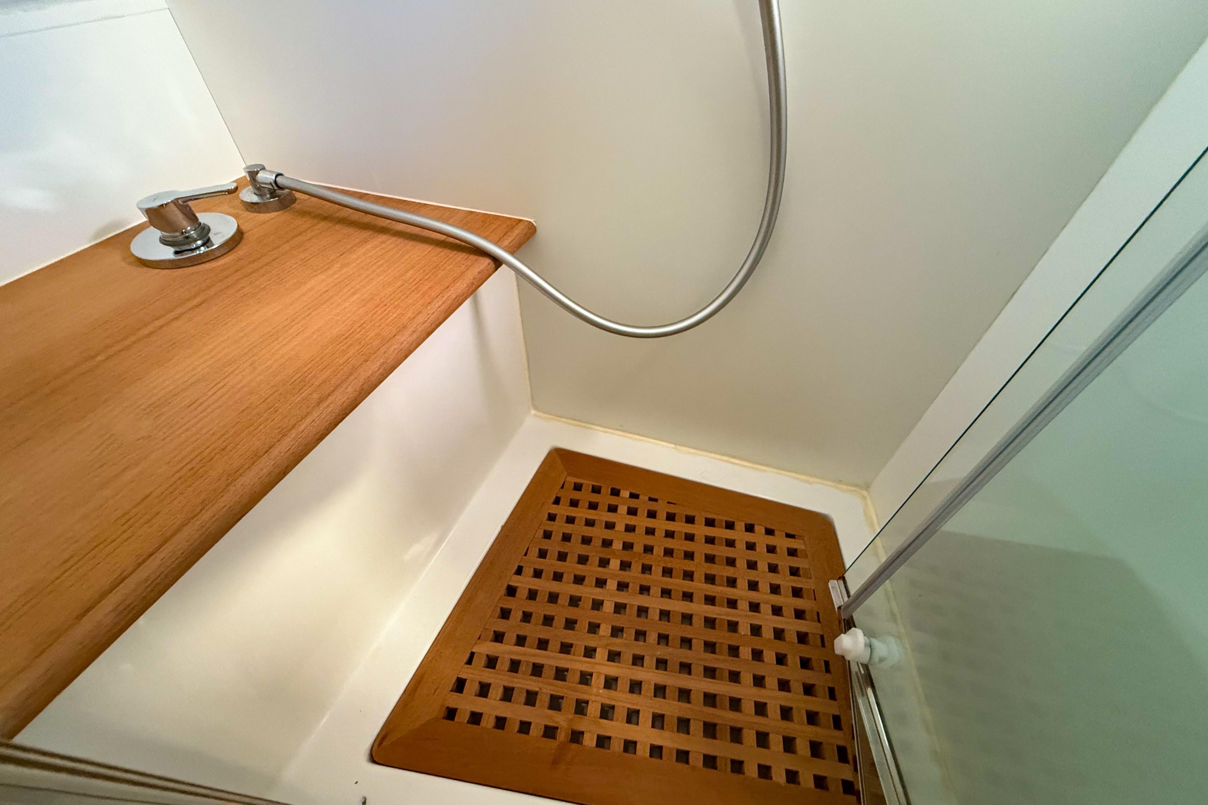 Shower area in 2023 Apreamare GOZZO 35 yacht with wooden floor and modern fixtures.