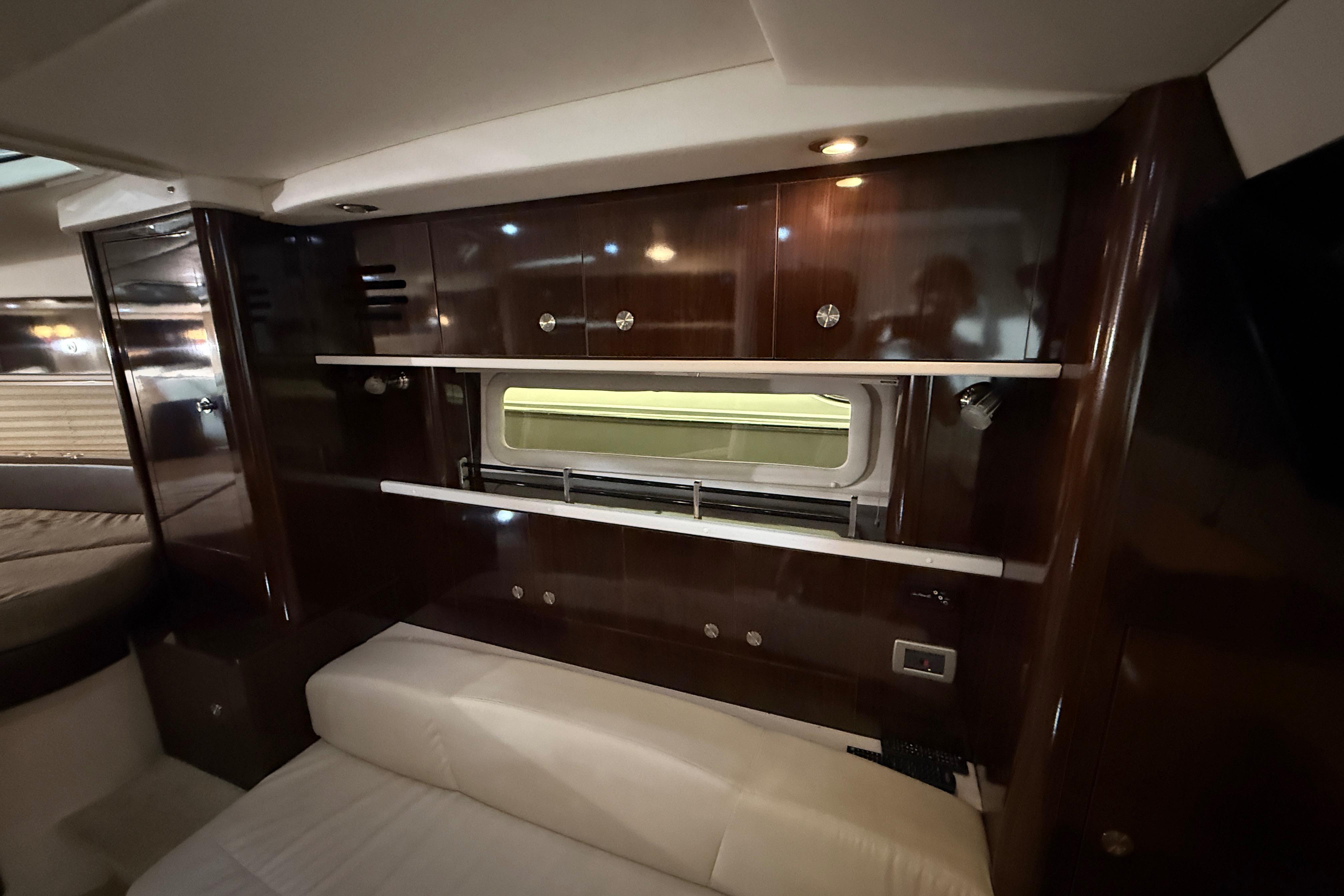 Luxurious interior of 2017 Sea Ray Sundancer 330 yacht with wood paneling and seating.