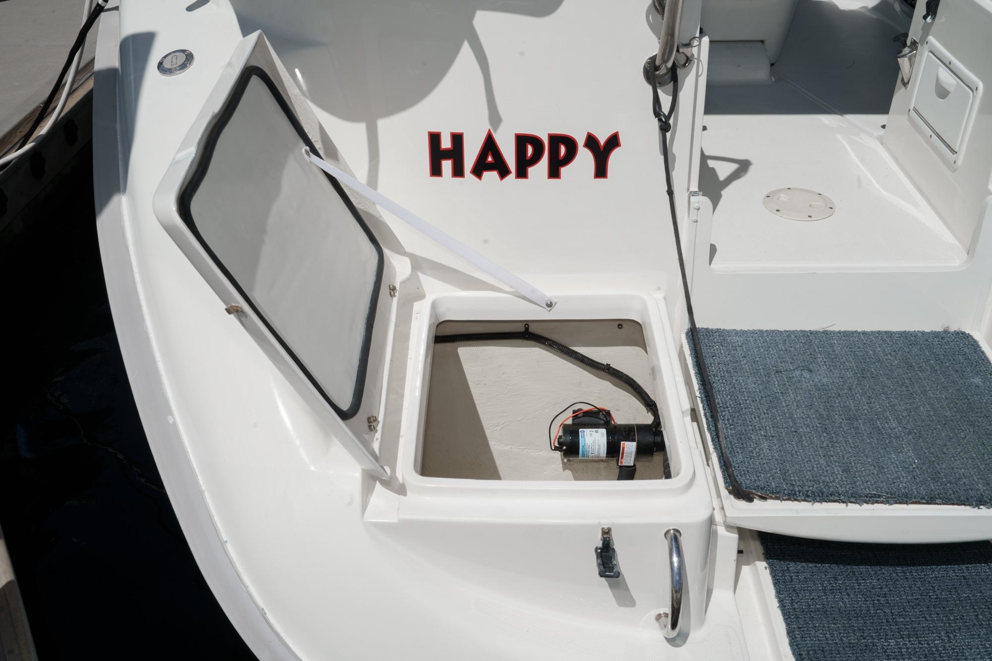 Open hatch on 1996 Hunter 376 sailboat deck with "HAPPY" text.