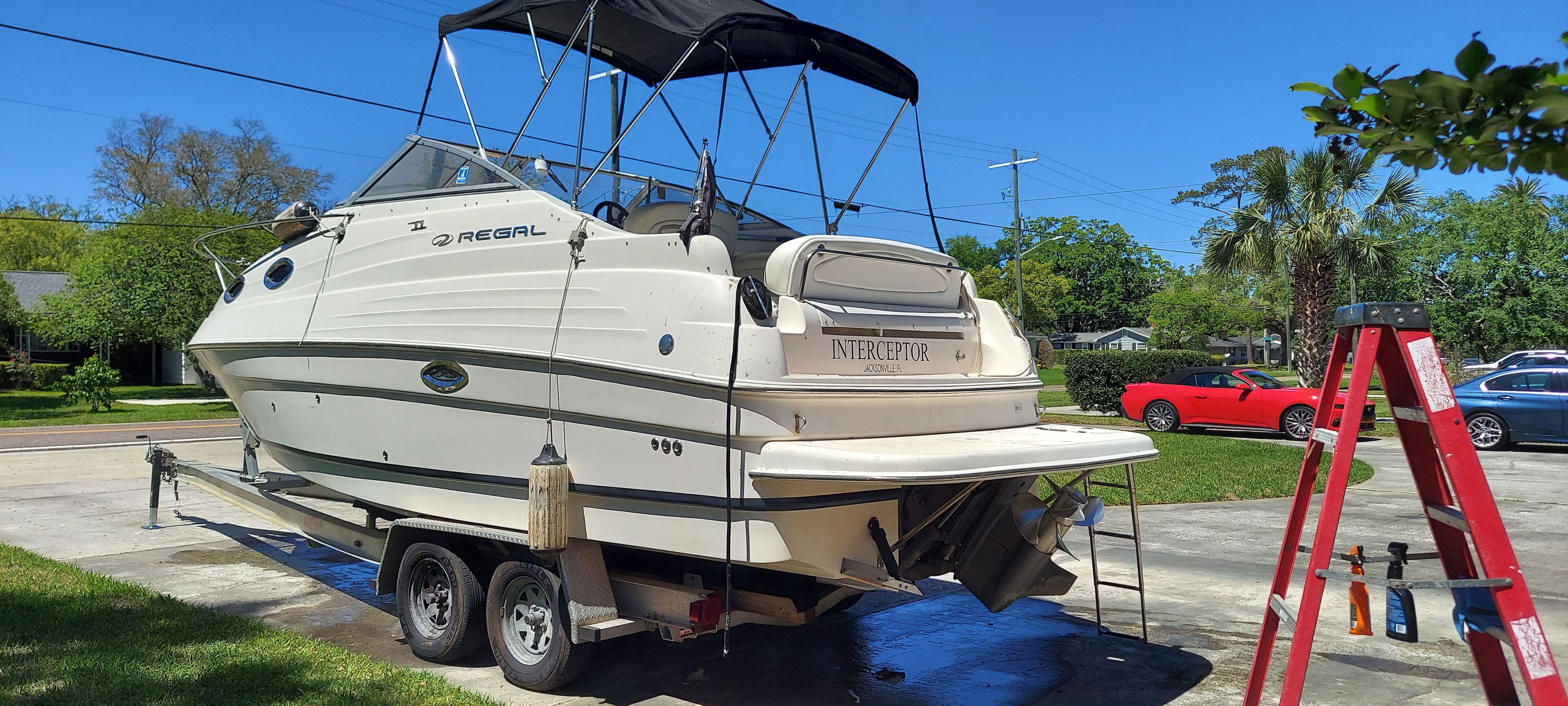 2004 Regal Commodore 2465 boat on trailer outdoors.