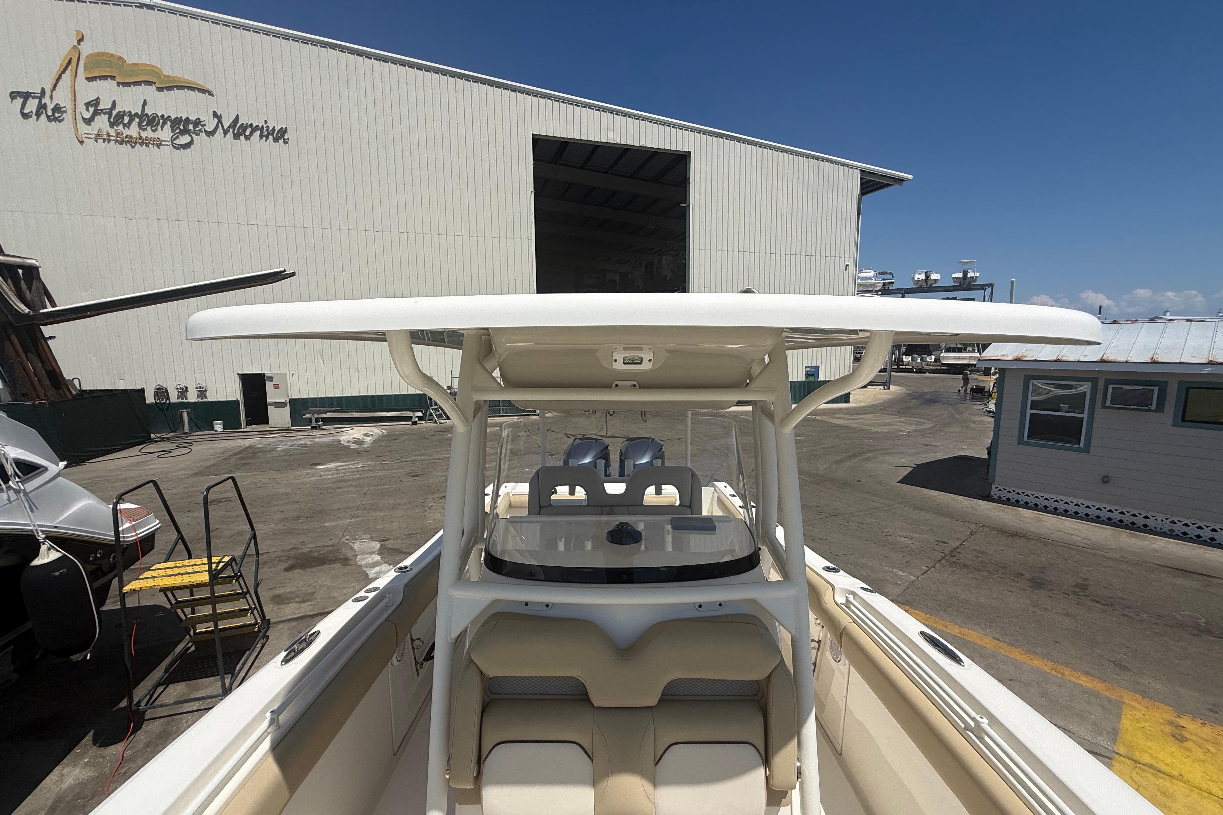 2019 Key West Billistic 281 Center Console boat at marina, showcasing helm and seating area.