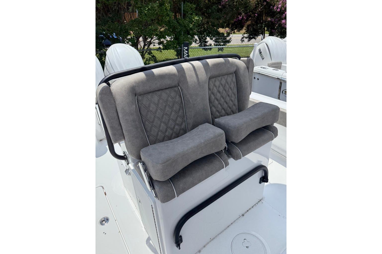 2026 Sea Hunt Gamefish 27 Coffin Box boat seats with gray upholstery and diamond stitching.