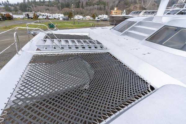 Deck view of 2025 Shuttleworth 52 AeroRig yacht with netting and sleek design.