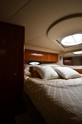 Luxurious cabin interior of 2010 Cruisers Yachts 390 Sports Coupe with plush bedding.