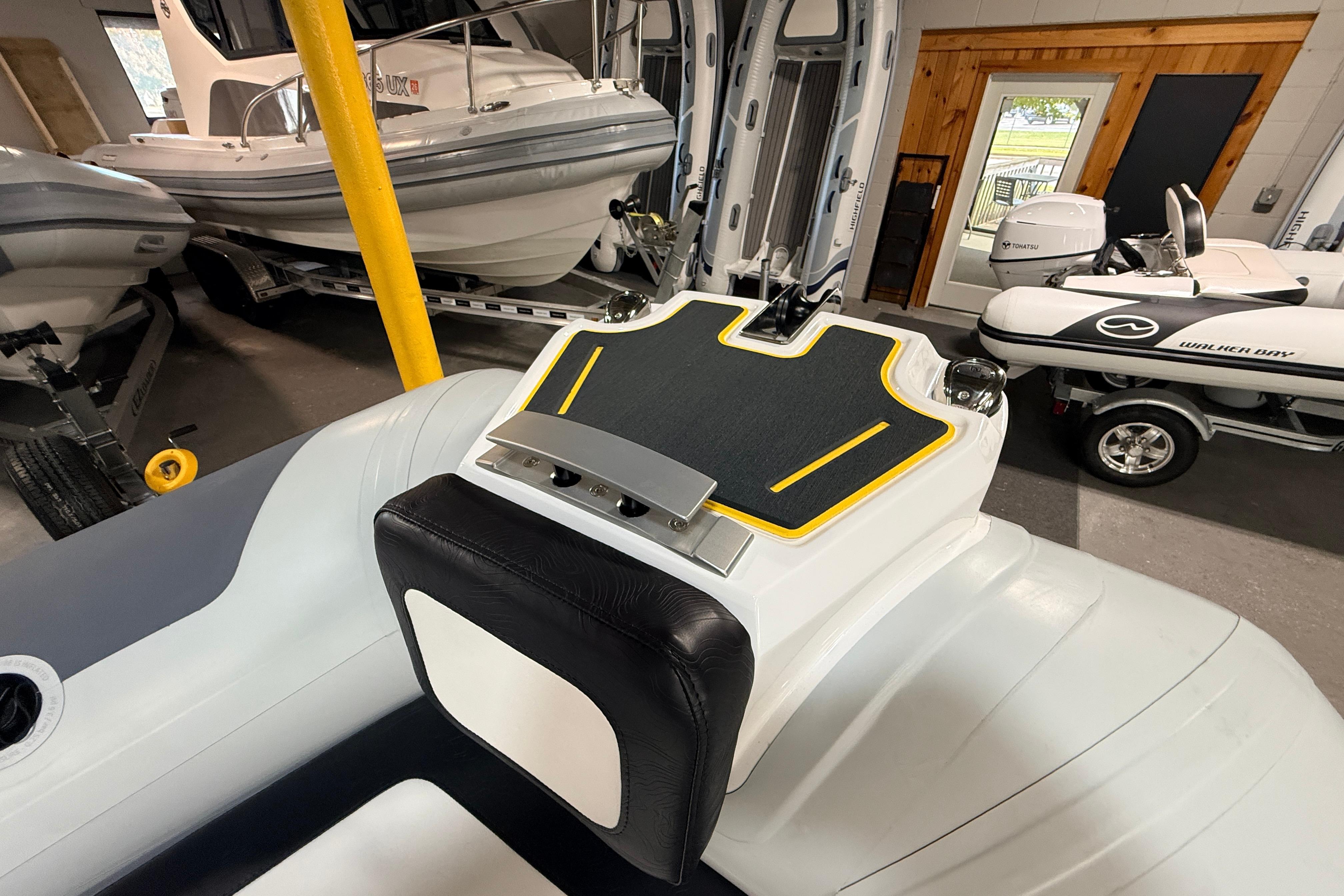 2026 Highfield VELOX 560 boat interior, showcasing sleek design and modern features in a showroom.