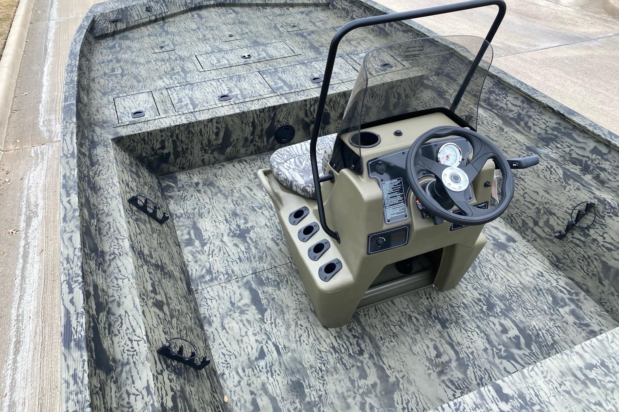 2026 Tracker Grizzly 2072 CC boat with camo design and central steering console.
