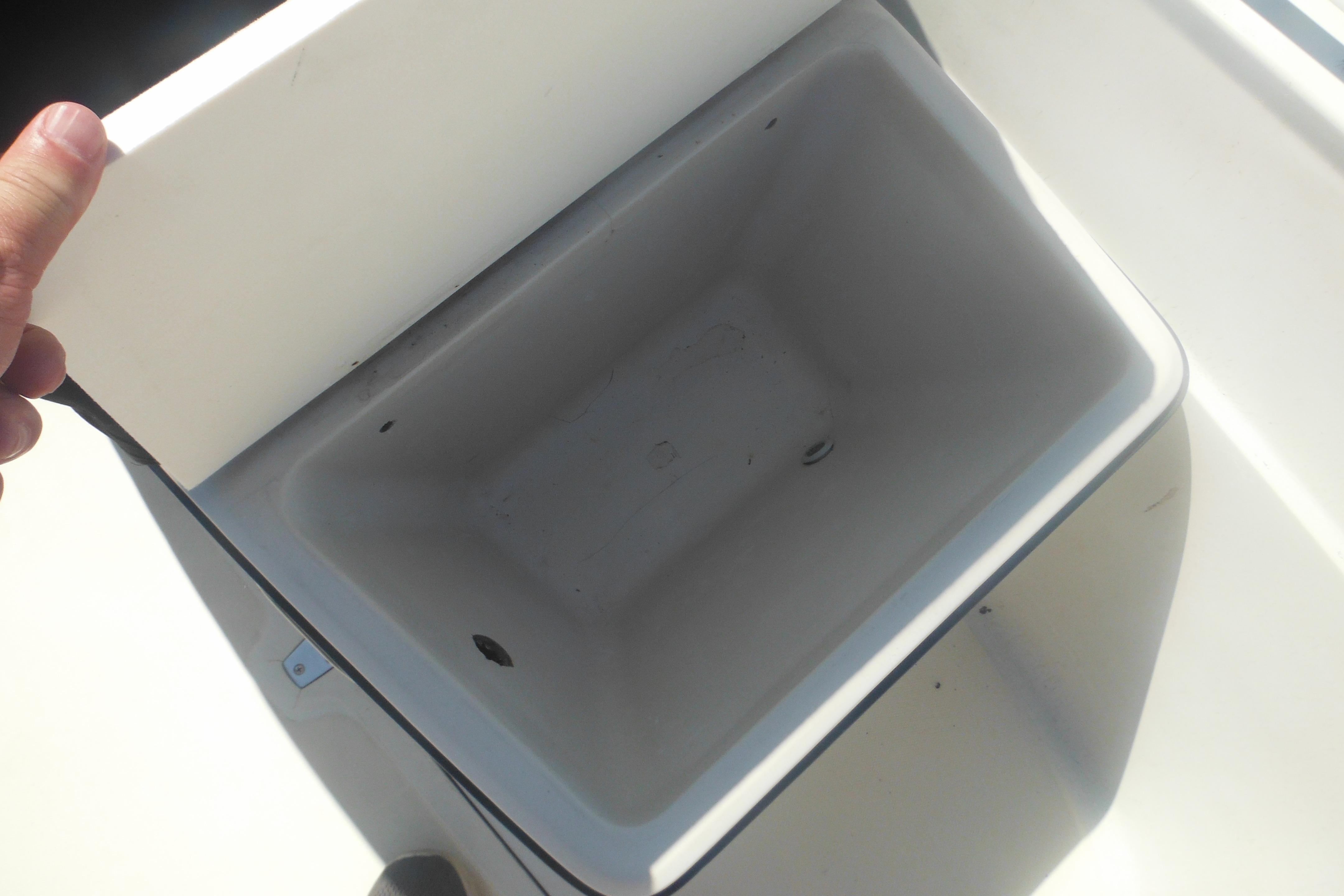 Open storage compartment on a 1991 Boston Whaler 16 SL boat.