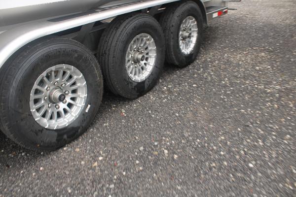 Triple axle trailer with silver alloy wheels for 2024 Fountain 34 SC boat.