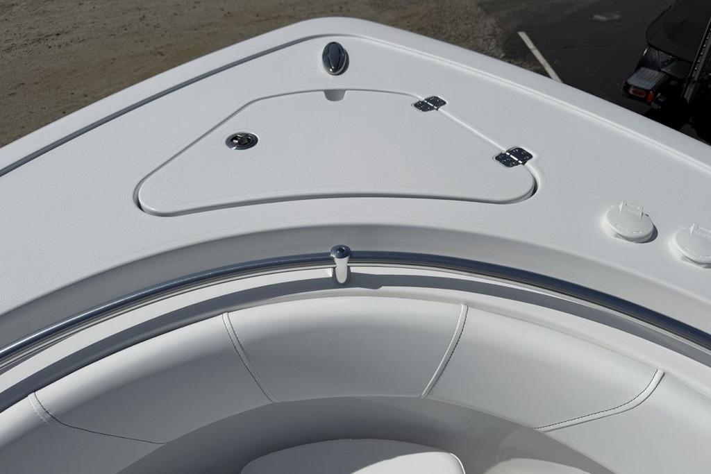 2026 Sportsman Open 252 Center Console boat, featuring sleek white seating and storage compartment.