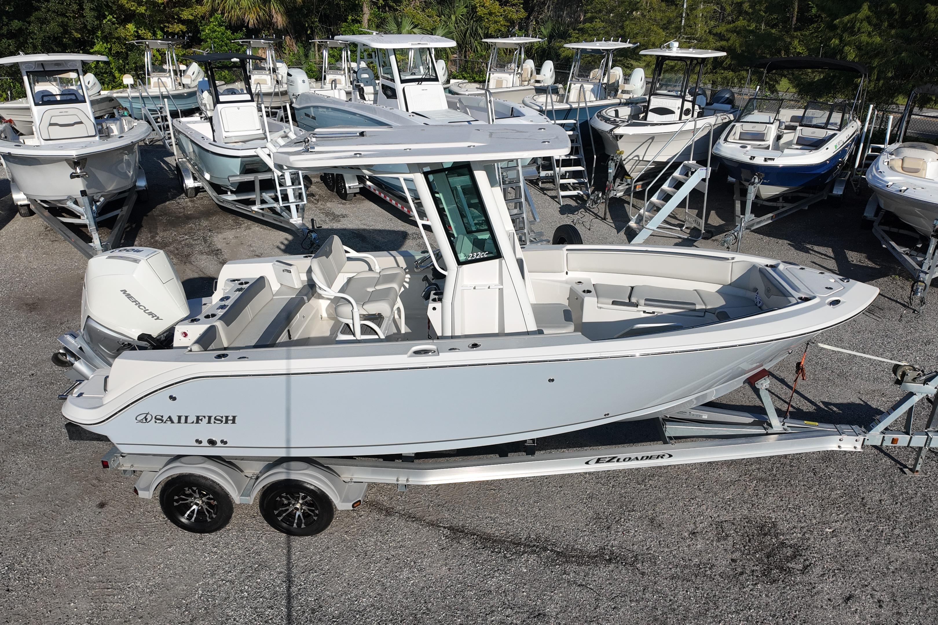 2026 Sailfish 232 CC boat on trailer, surrounded by other boats in a marina.