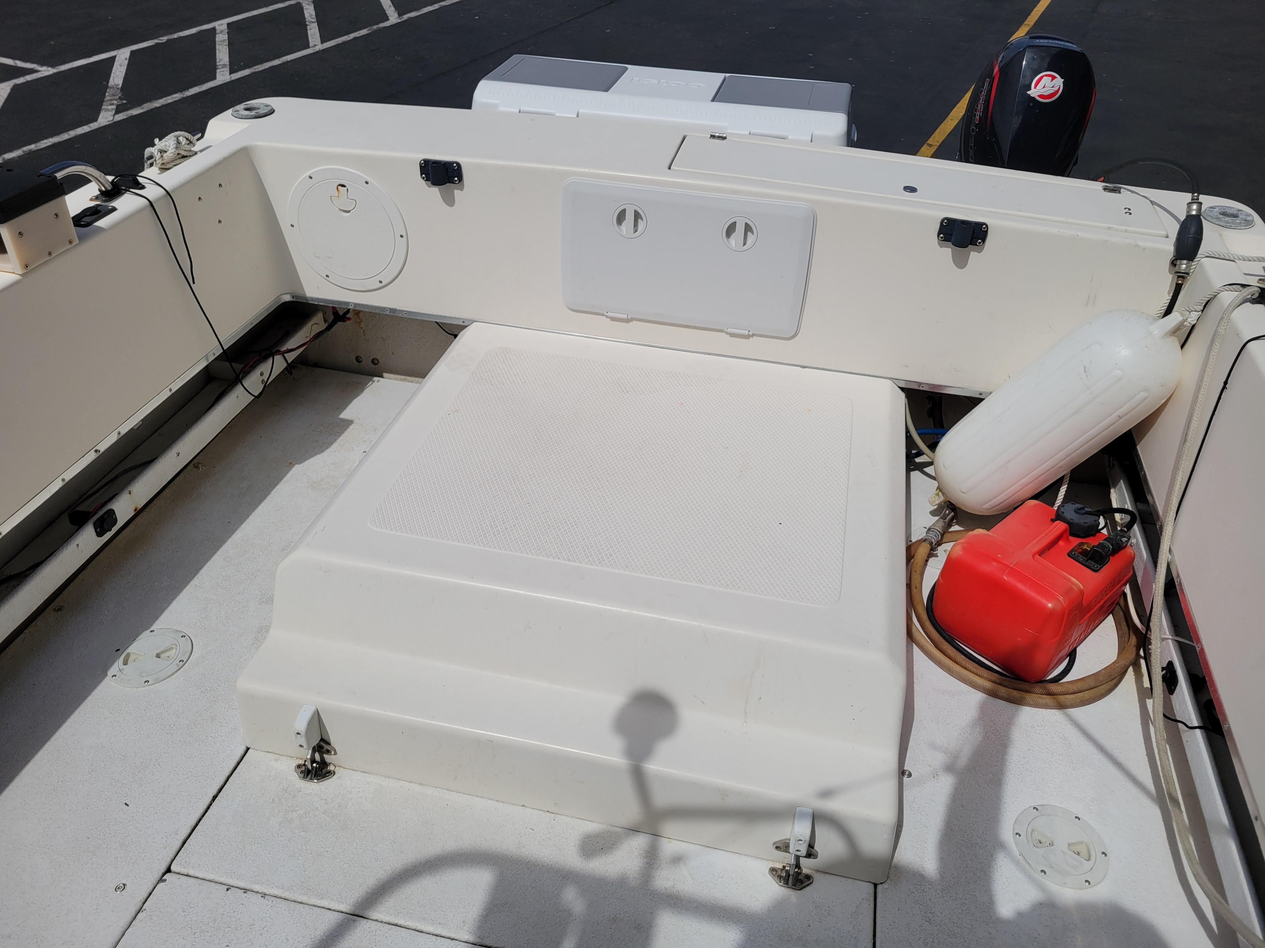 1999 SeaSport 2400 XL Limited boat deck with storage compartments and equipment.