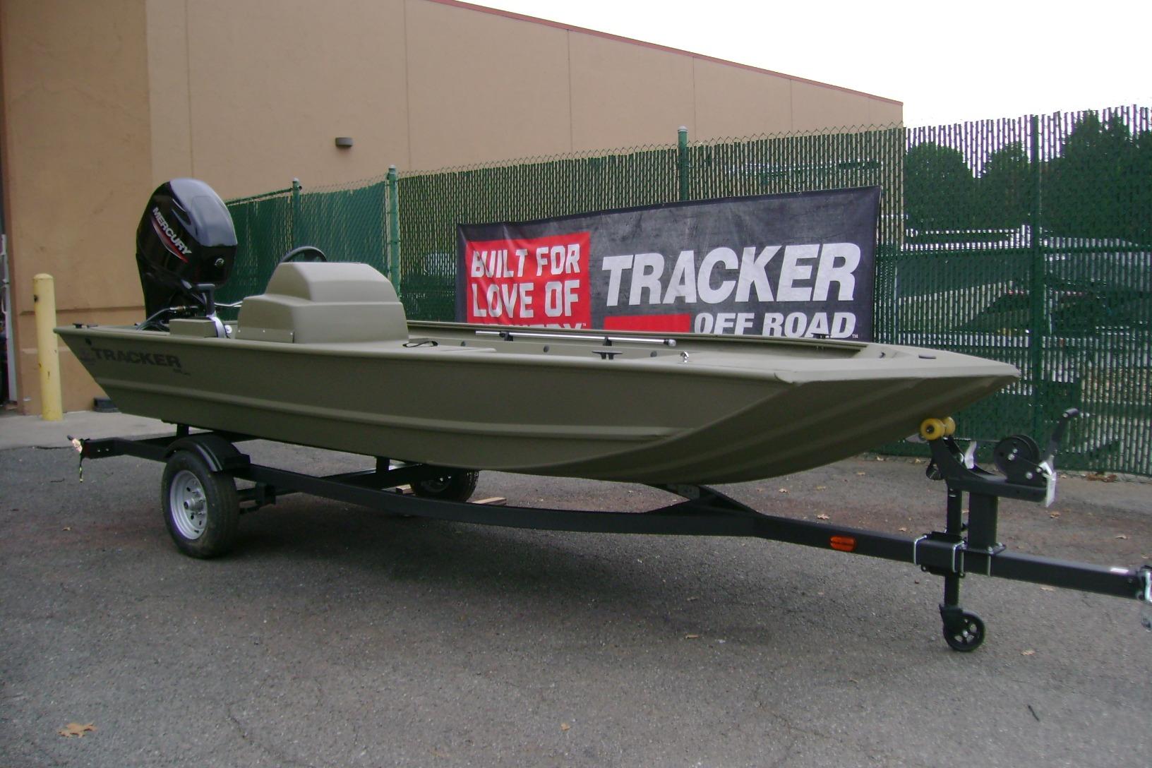 2026 Tracker Grizzly 1648 SC boat on trailer, displayed outdoors.