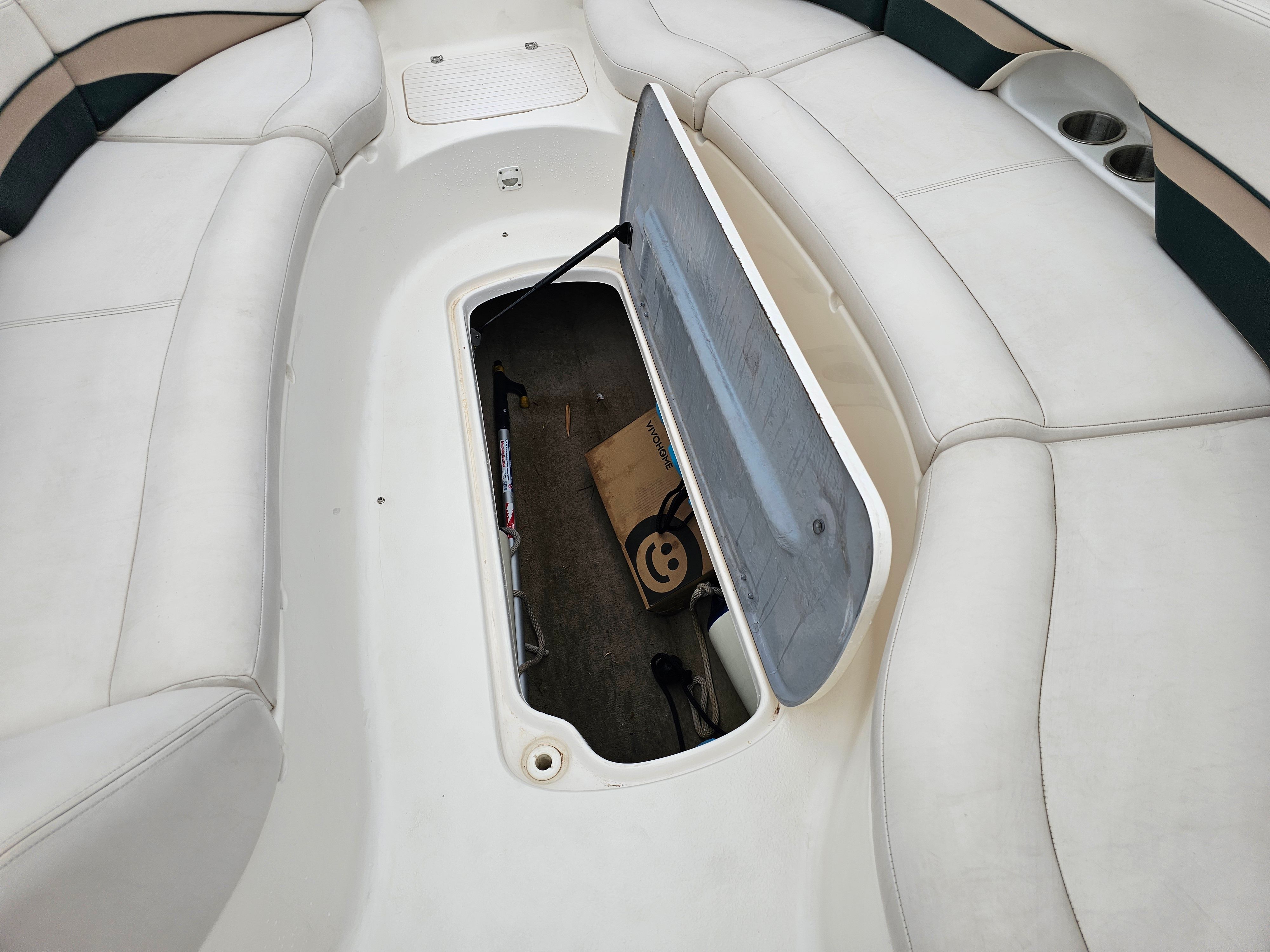 Interior of 1998 Chaparral Sunesta 252 with open storage compartment.