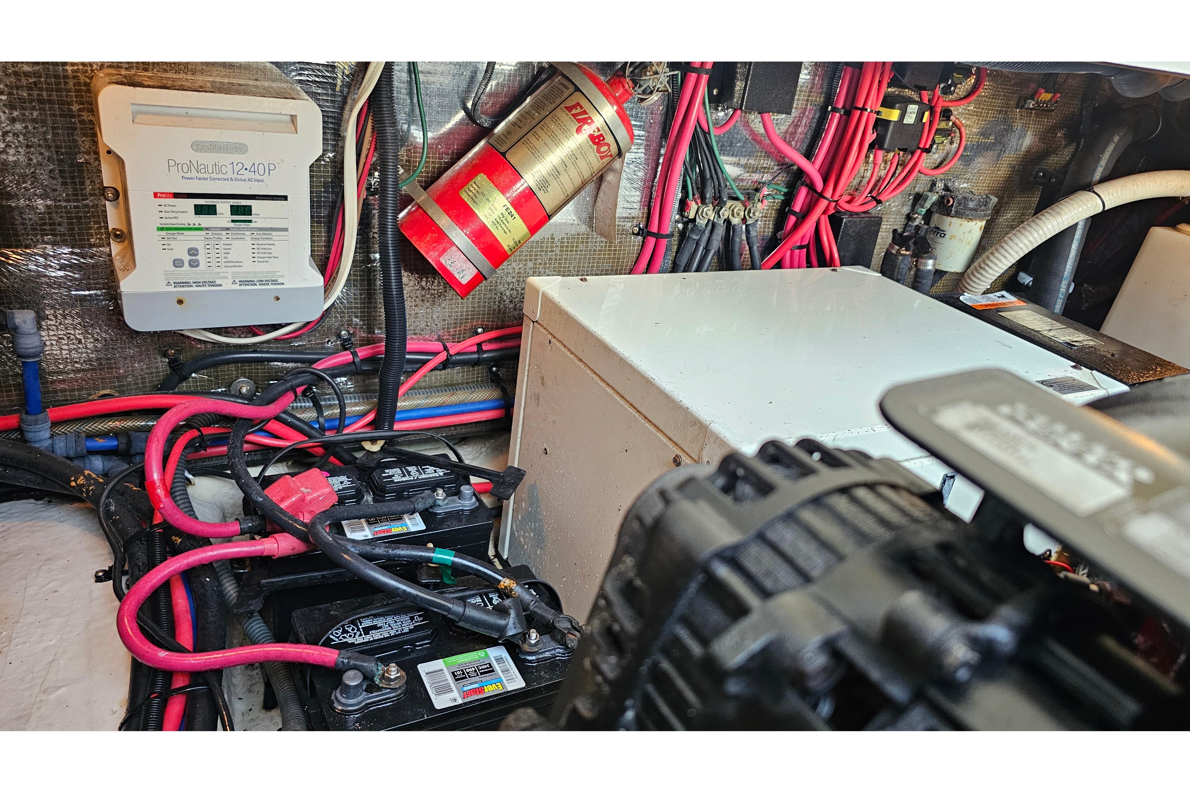 Engine compartment of a 2005 Regal 3060 Window Express with wiring and fire extinguisher.