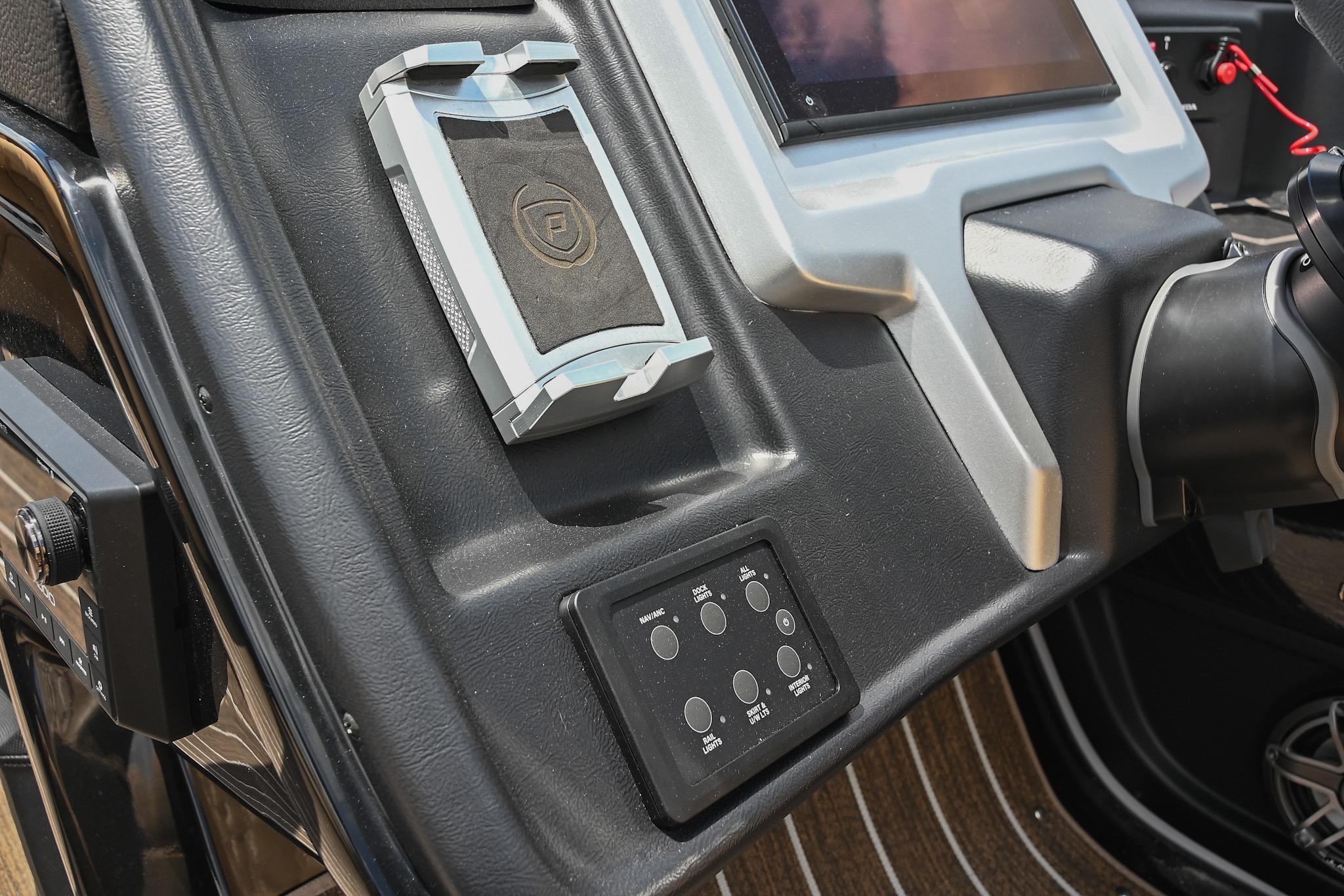 Dashboard of 2023 Premier 270 Intrigue RF boat with control panel and steering wheel.
