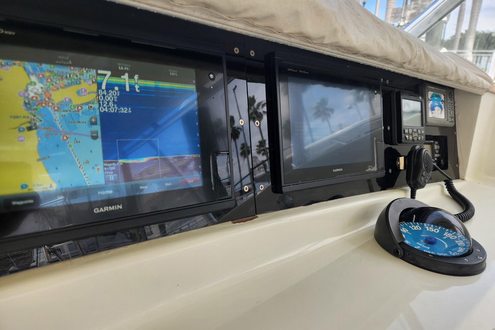 Control panel of a 1987 Young Brothers Custom Sport Fish boat with navigation equipment.