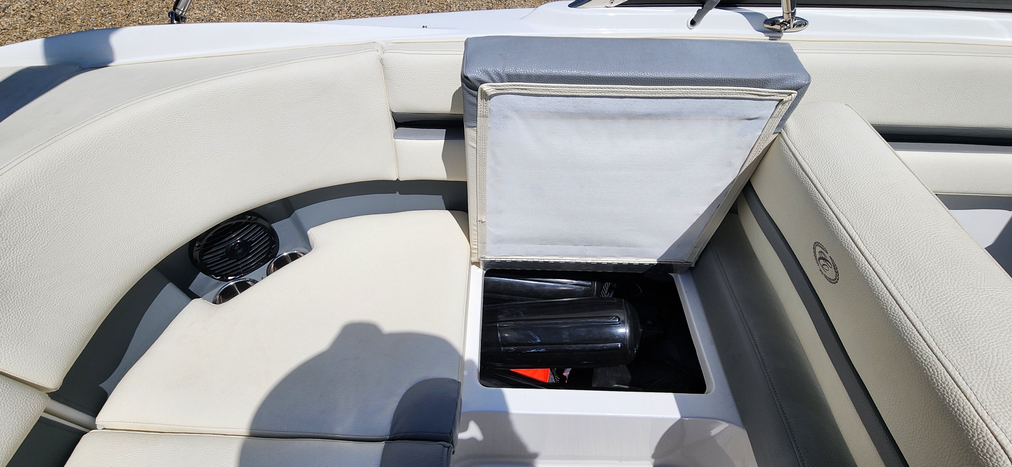 A Cobalt CS22 boat with an open storage compartment and speaker.