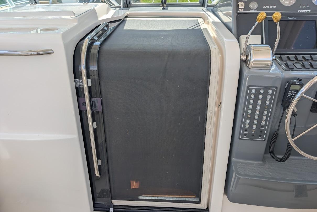 Control panel and cabin door of a 2000 Pursuit 3400 Express boat.