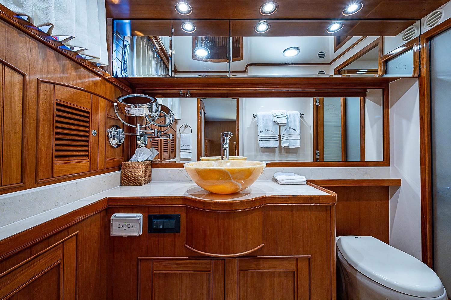 Luxurious Marlow 80 Explorer 2014 yacht bathroom with elegant wood finish and modern fixtures.