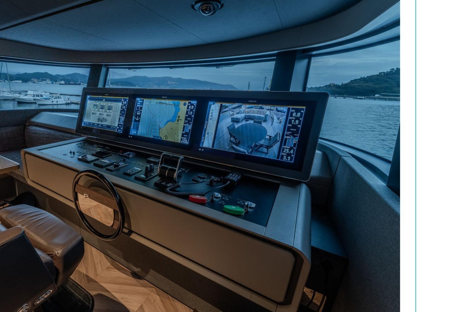 Control panel of 2025 Ferretti Infynito 90 yacht with navigation screens and scenic view.