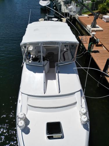 1992 Sea Ray 350 Express Bridge docked at marina.