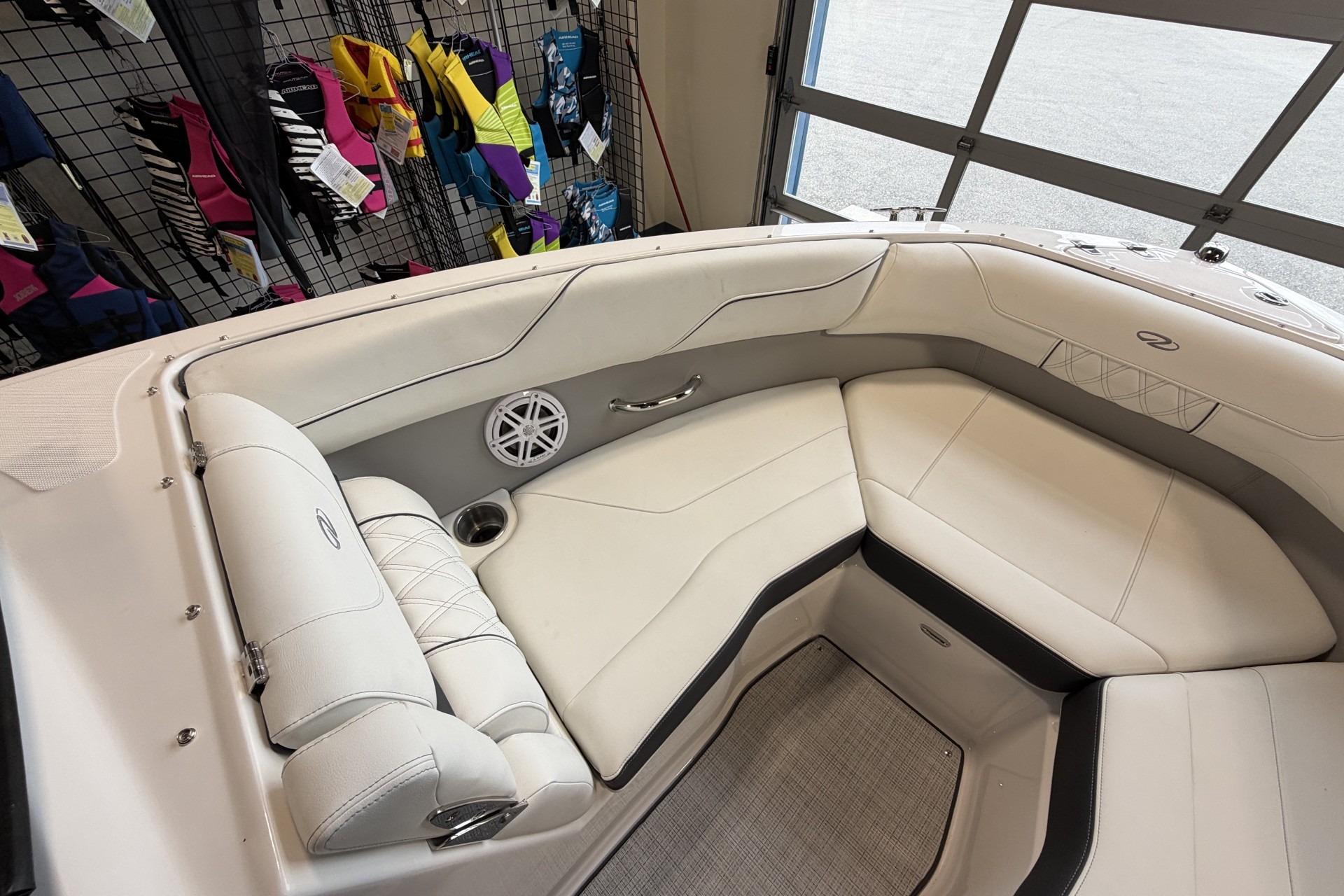 Luxurious interior of 2027 Regal LS2 boat with white seating and speaker system.