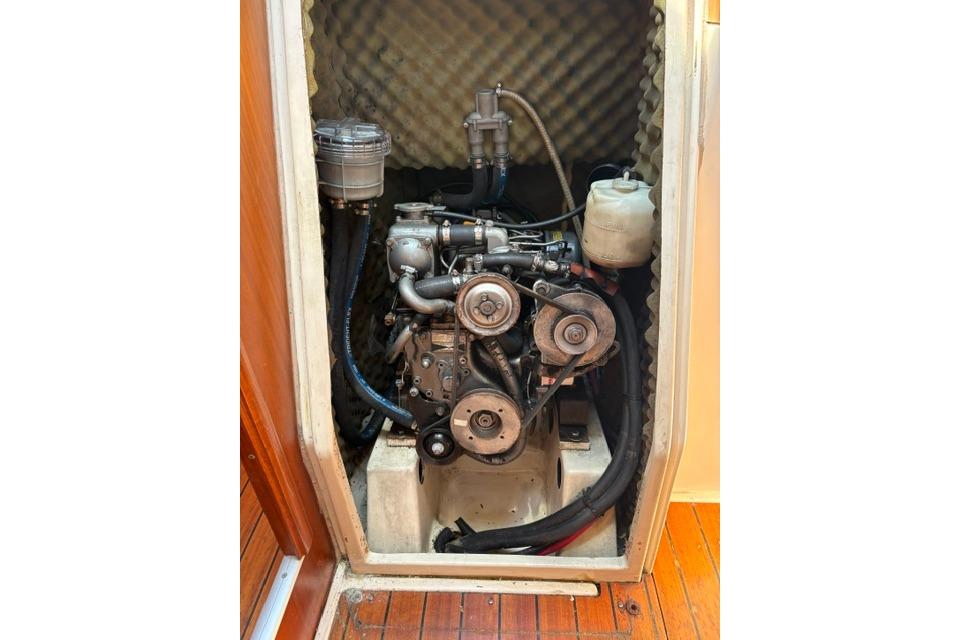 Engine compartment of a 2000 Beneteau Oceanis 321 sailboat, showcasing mechanical components.